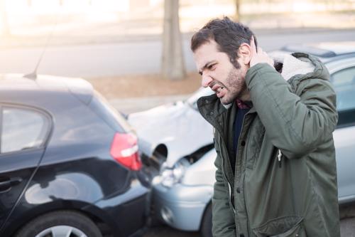 A man holding his neck after an Uber accident.
