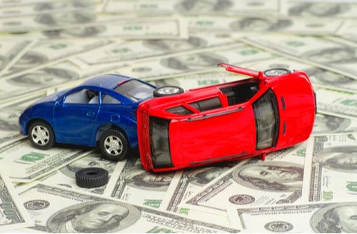 Concept of car accident lawyer fee, toy cars on money
